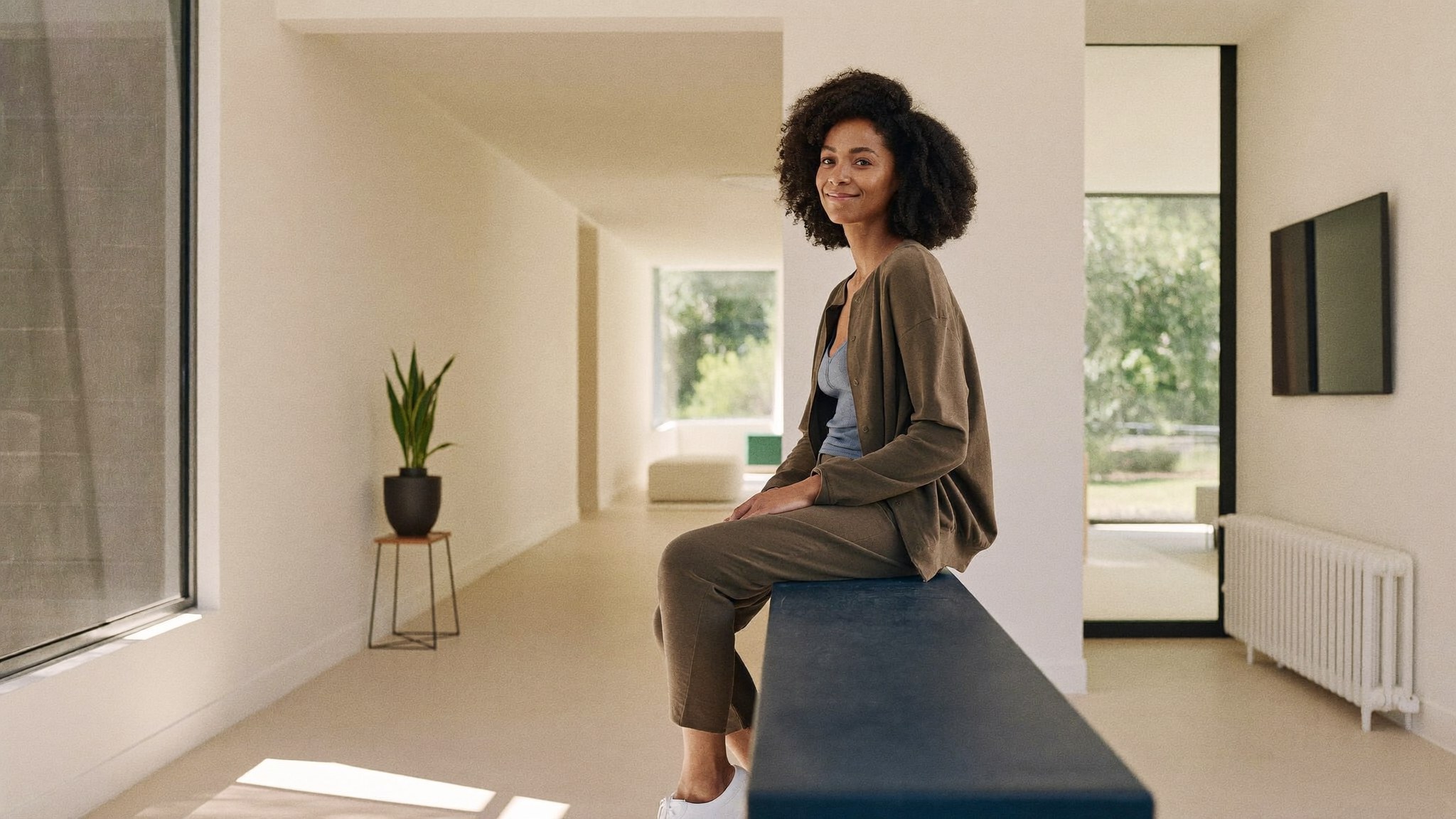 A mother at ease in her bright modern home, relieved about the timing of her financing plan